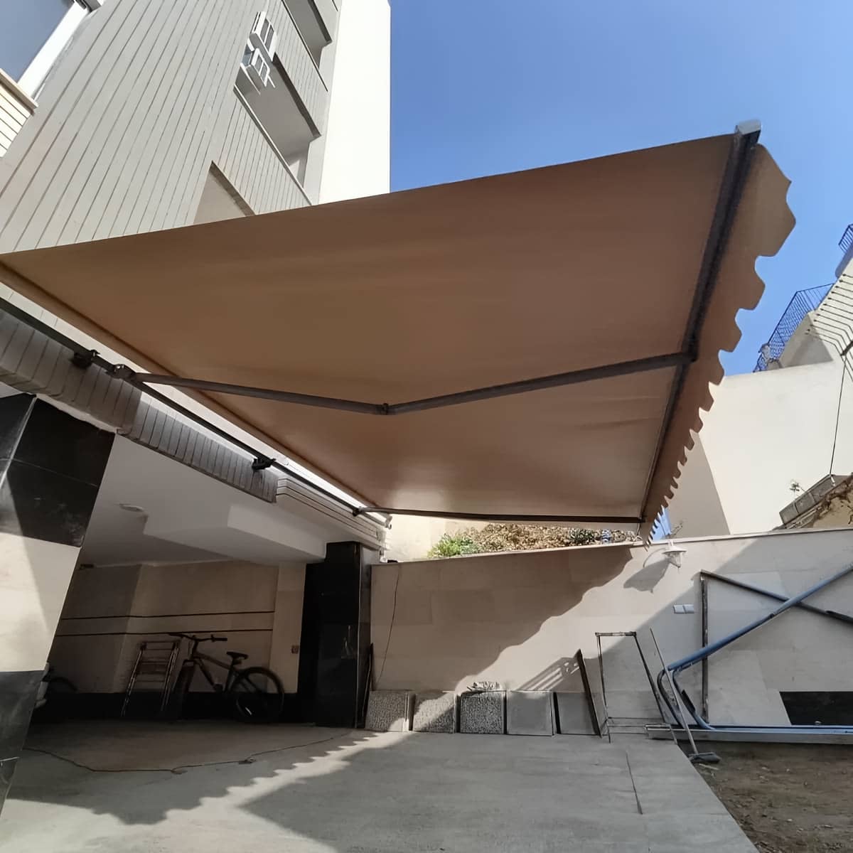 سایبان برقی بازویی با فریم فلزی روی نما