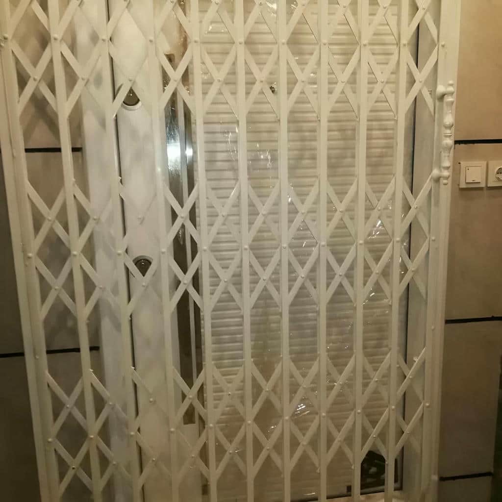 درب آکاردئونی ویلا و باغ با طرح فلزی مشکی